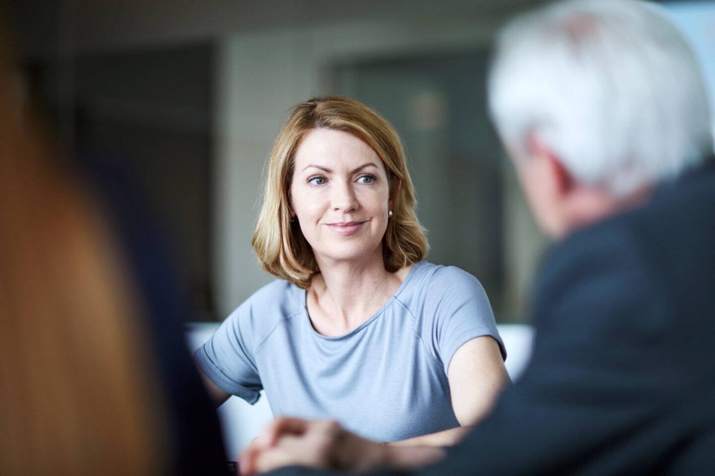 Businesswoman listening to businessman in meeting